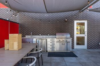 A kitchen with a red cabinet and a white door.